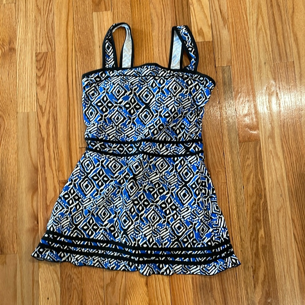 One piece bathing suit. Bra pads, bottoms attached. Cute ruffle at bottom.